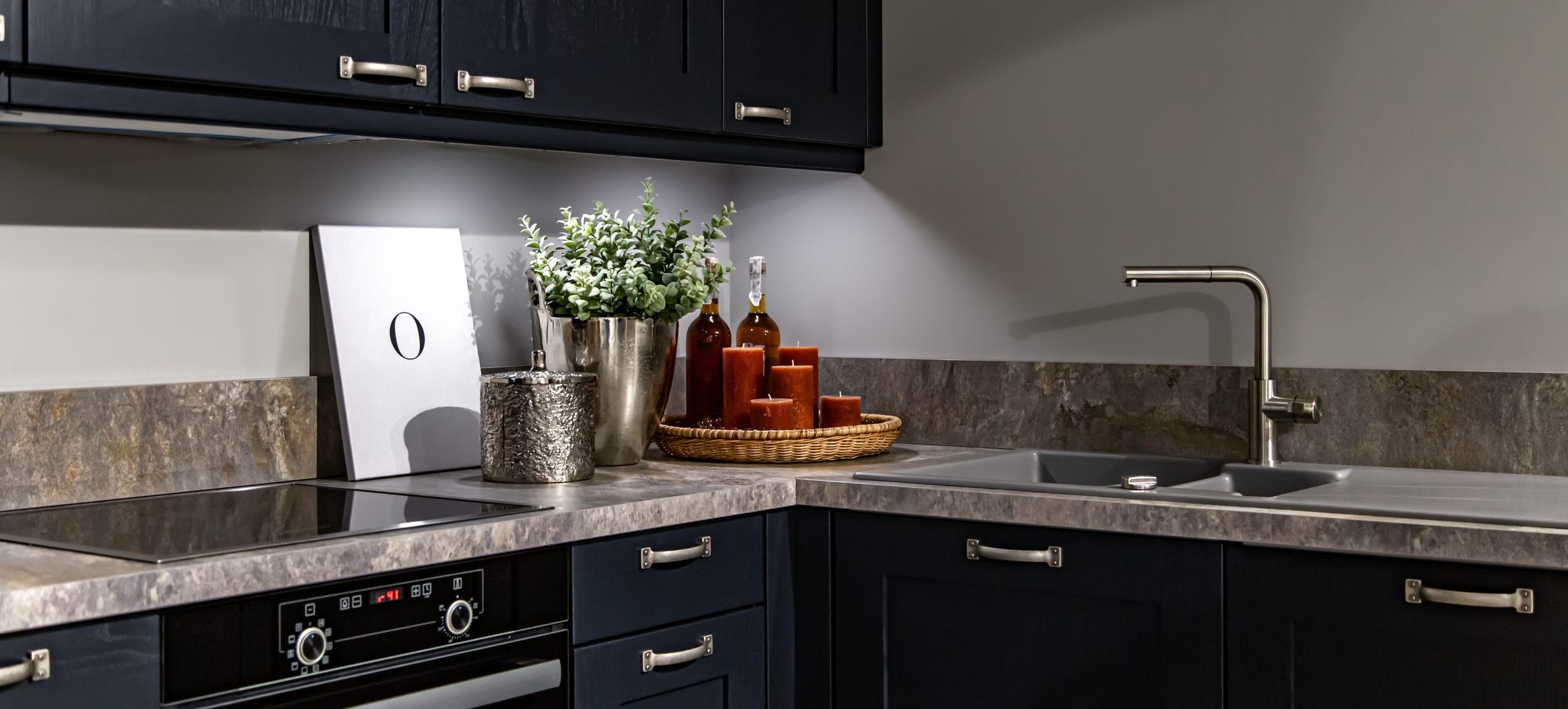 Dark kitchen cabinets with metal pulls or knobs in home interior.